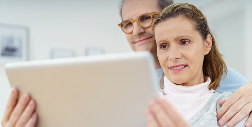 Couple on tablet at home