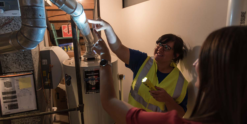 Employee showing customer water heater