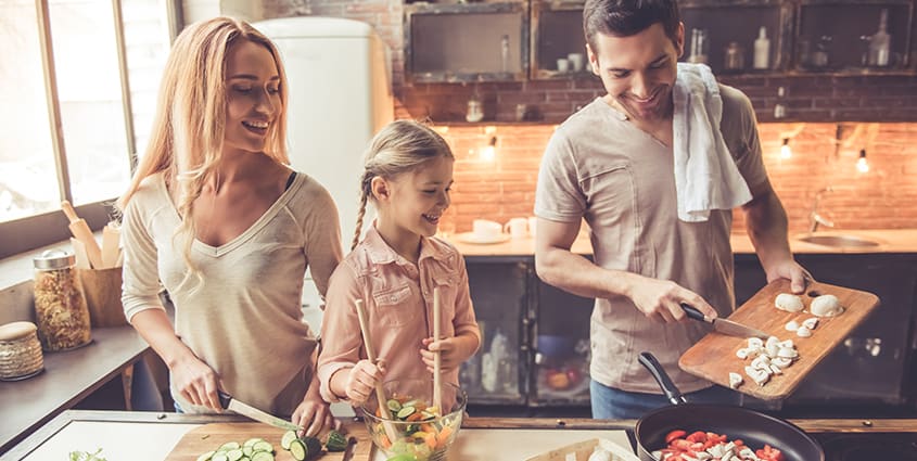 Family cooking in kitchen