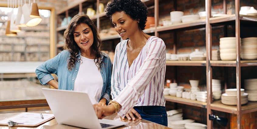 Two business owners standing at a computer
