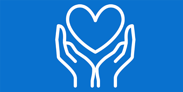 Hands holding up heart against blue background