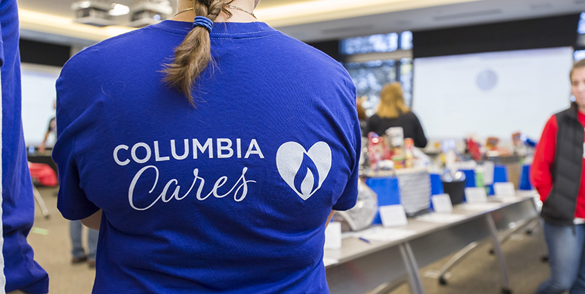 Employee facing away wearing Columbia Cares shirt