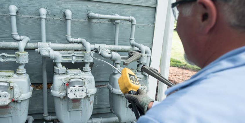 columbia gas worker inspecting gas meters