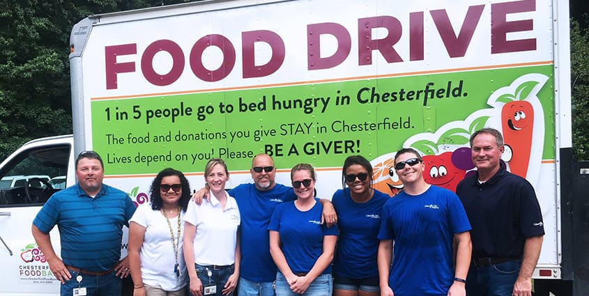 Columbia Gas employees standing in front of a food drive truck after volunteering