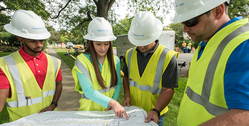 Field employees reviewing map