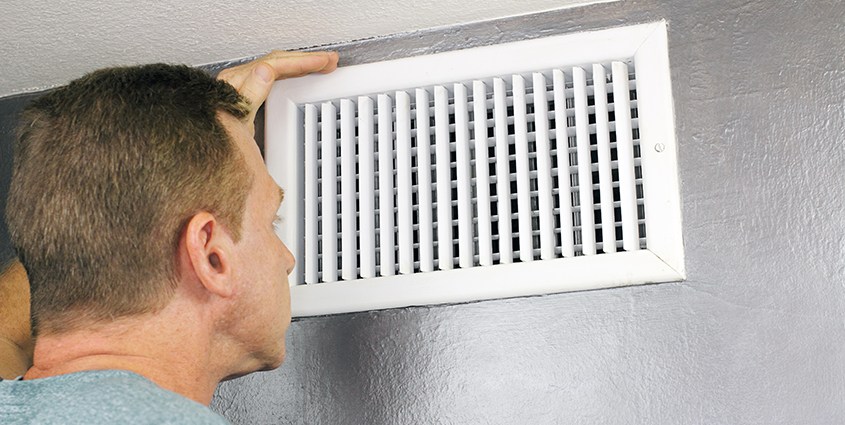 Man looking at venting in home